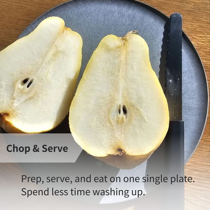 A pear cut in half on a CHOPLATE, demonstrating its functionality as a high-quality Japanese cutting board.