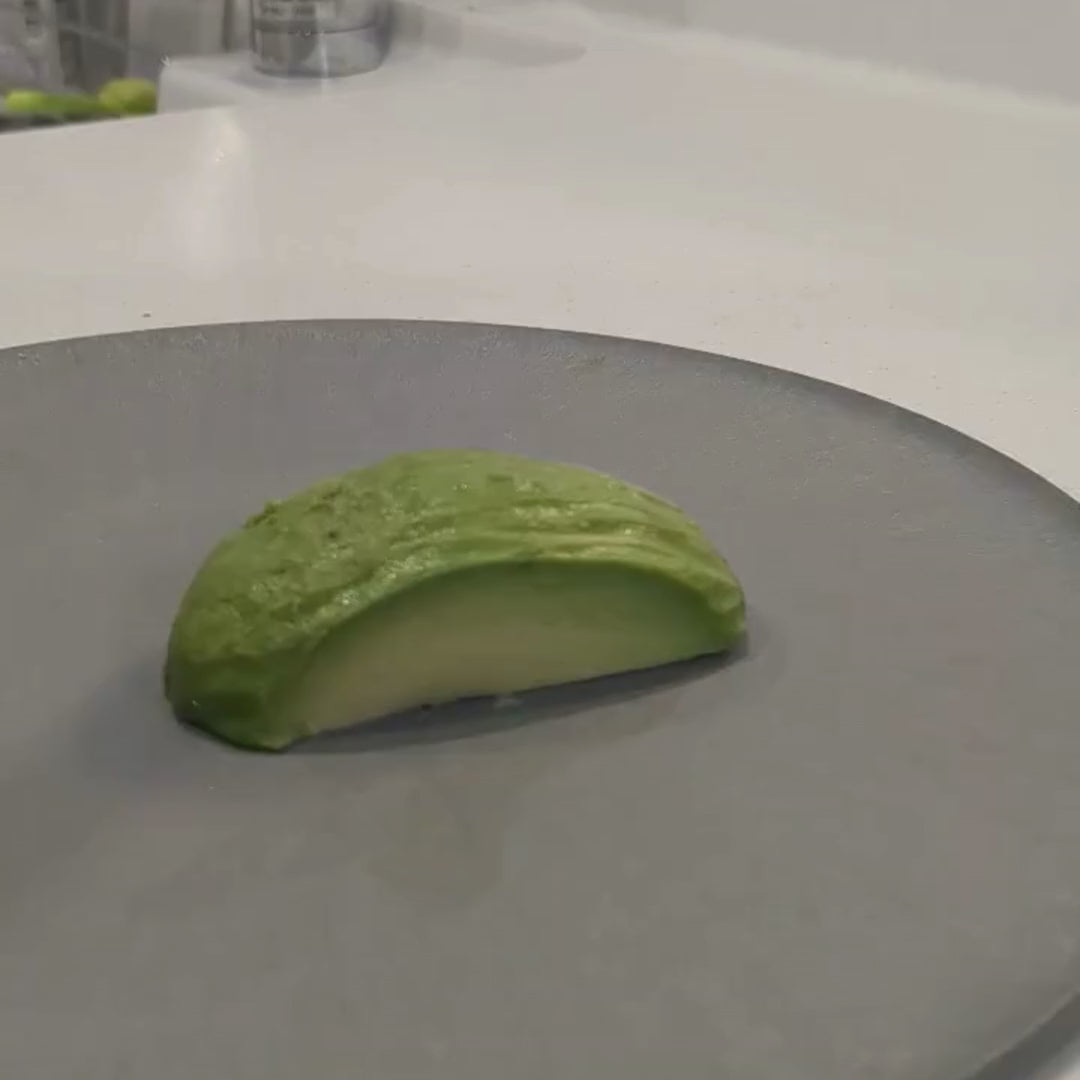 Cutting an avocado on a CHOPLATE, showing the durability and scratch-resistant material of this Japanese plate.